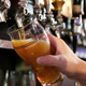 Sam Adams beer being poured into a glass from a tap
